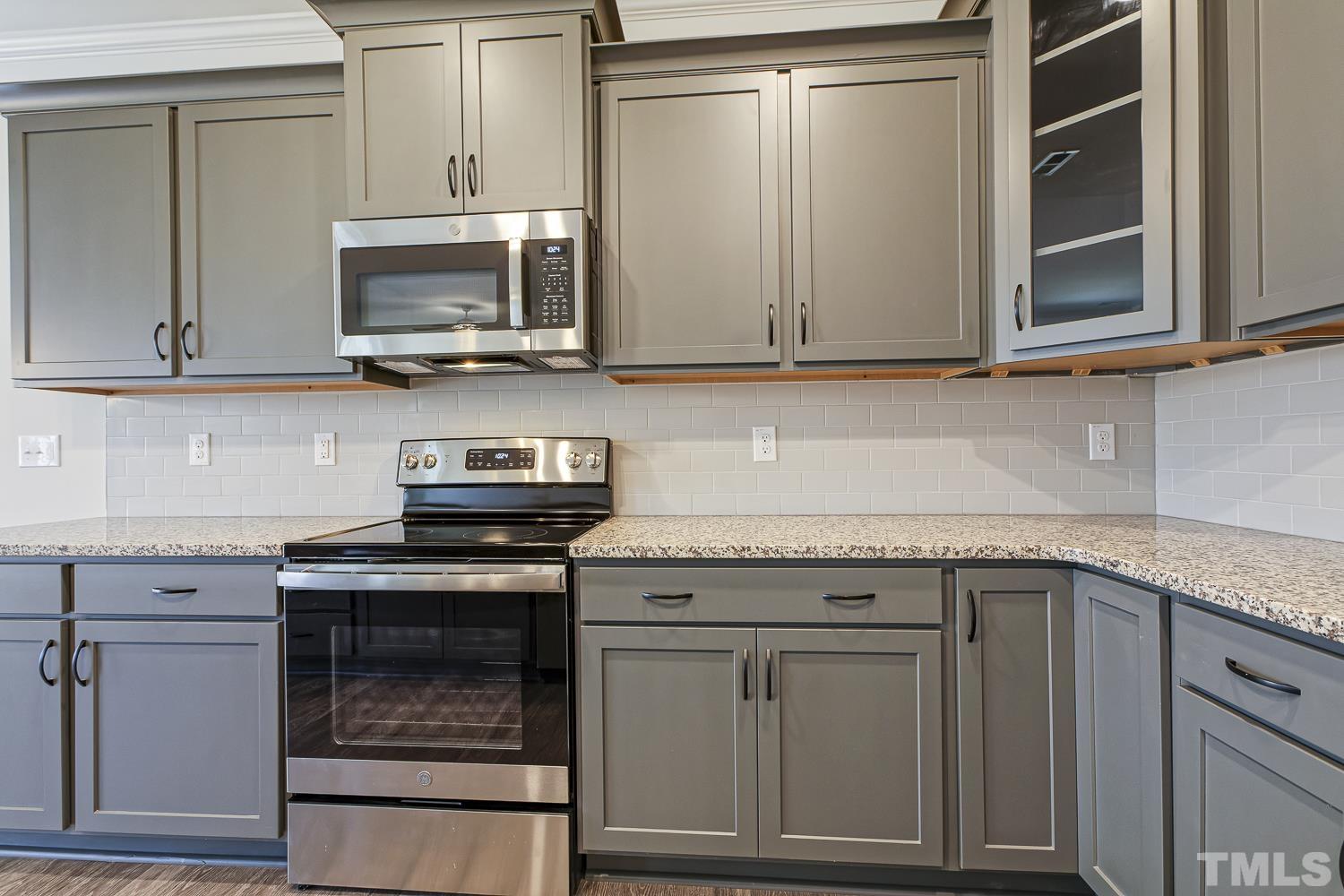 435 Cliffview Drive Garner, NC 27529 - Photo 10 of 45 a kitchen with granite countertop cabinets stainless steel appliances and a sink