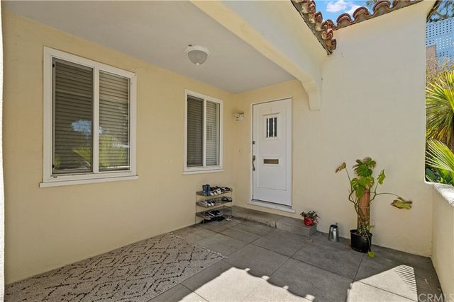 a room with painting on the wall and a window