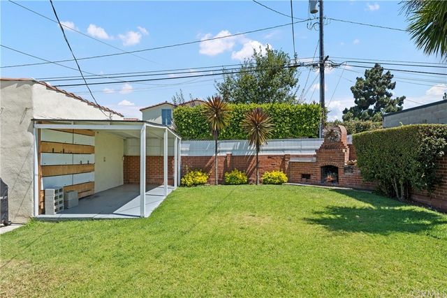 a view of a backyard with plants and a garden
