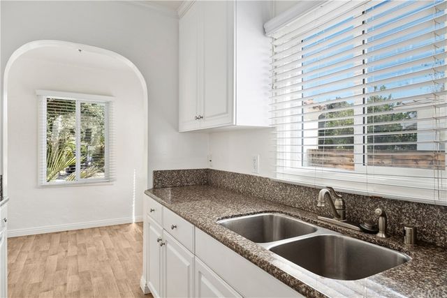 a kitchen with granite countertop a sink and a window