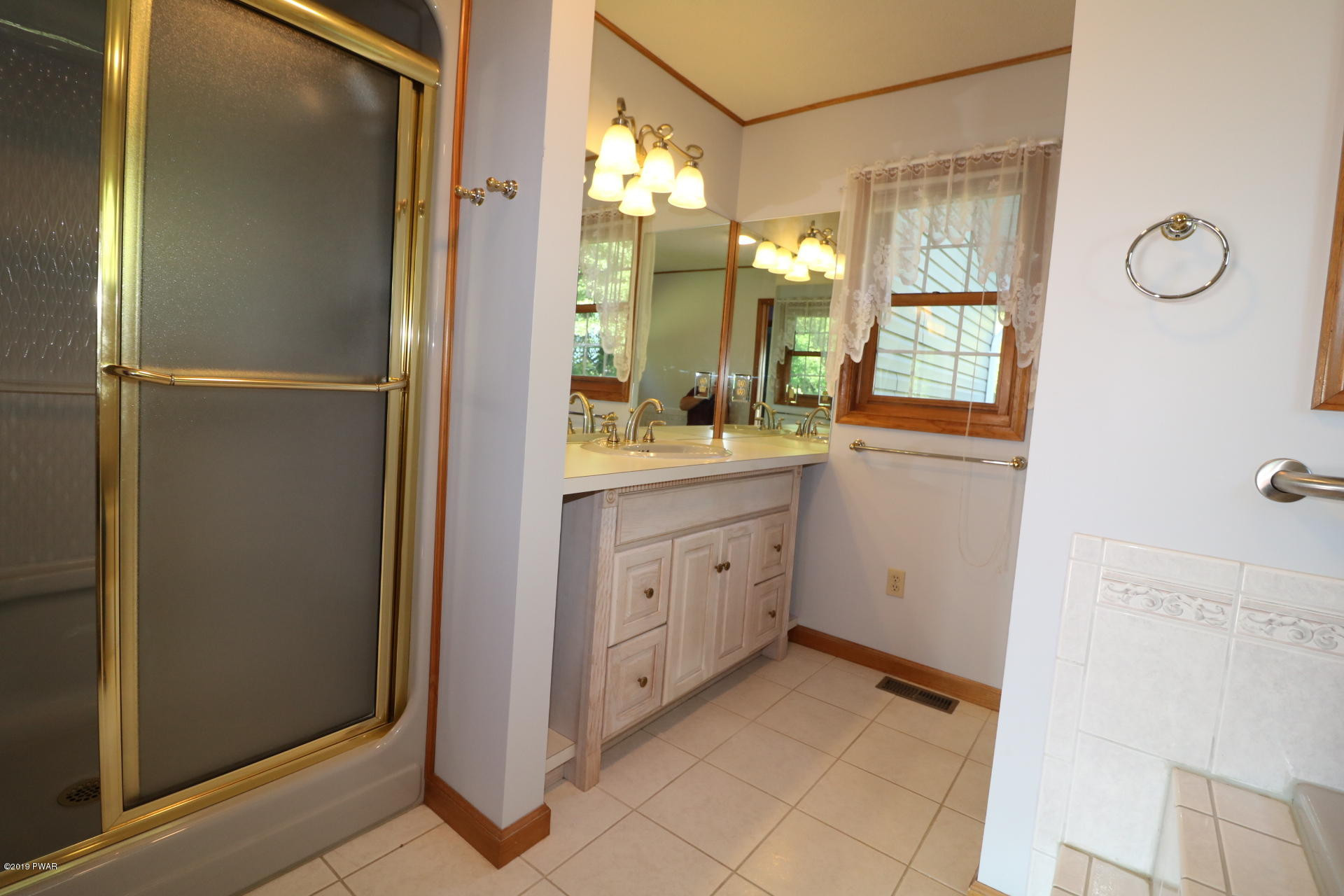 53 Savitz Road Lake Ariel, PA 18436 - Photo 33 of 53 a bathroom with a granite countertop sink a mirror and a shower