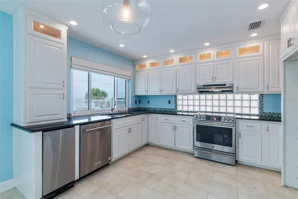a view of an empty room with a cabinet and a window