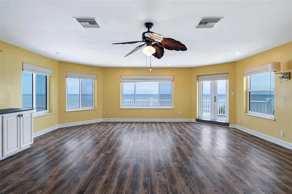 an empty room with windows and entrance