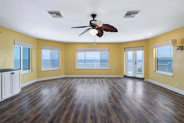 an empty room with windows and entrance