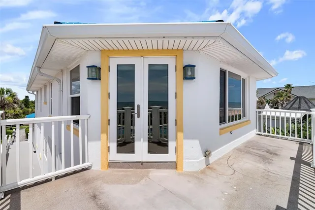 an empty room with wooden floor chandelier fan and windows