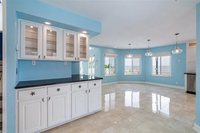a view of a livingroom with a fireplace cabinet and windows