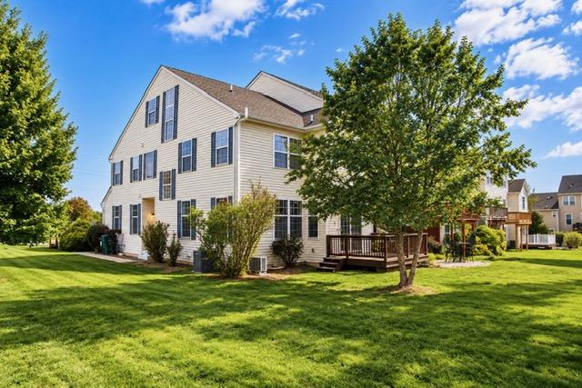 5439 Spring Ridge Drive West Macungie, PA 18062 - Photo 3 of 17 An expansive green lawn surrounds the exterior of this multi-level residential structure featuring a wooden deck.