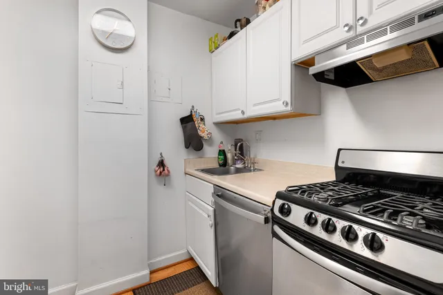 a white stove top oven sitting inside of a kitchen