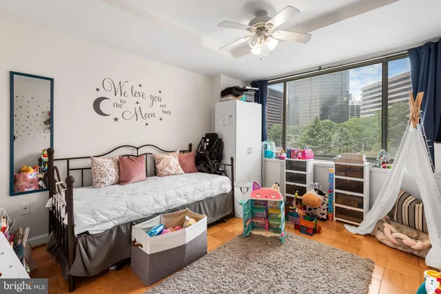 a bedroom with furniture and a large window