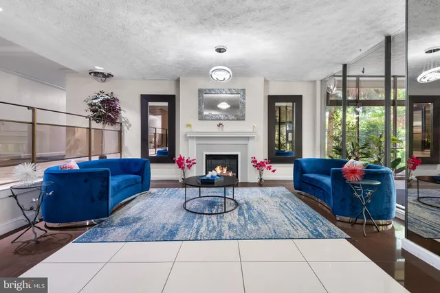 a living room with furniture a window and a fireplace