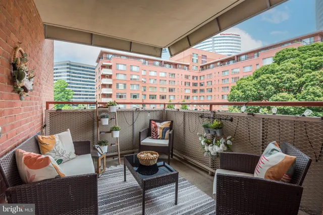 a balcony with furniture and a potted plant