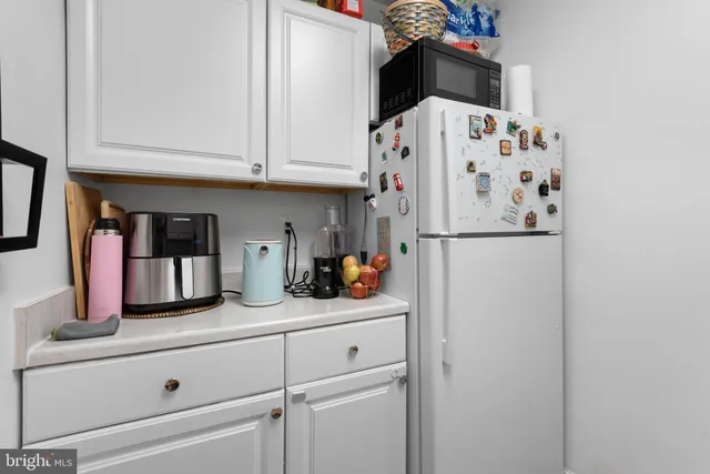 a kitchen with stainless steel appliances a refrigerator and cabinets
