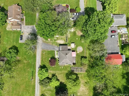 an aerial view of a house with a yard and lake view