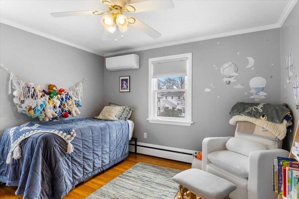 10 Earnshaw Street Boston, MA 02132 - Photo 15 of 35 a bedroom with a bed and a window