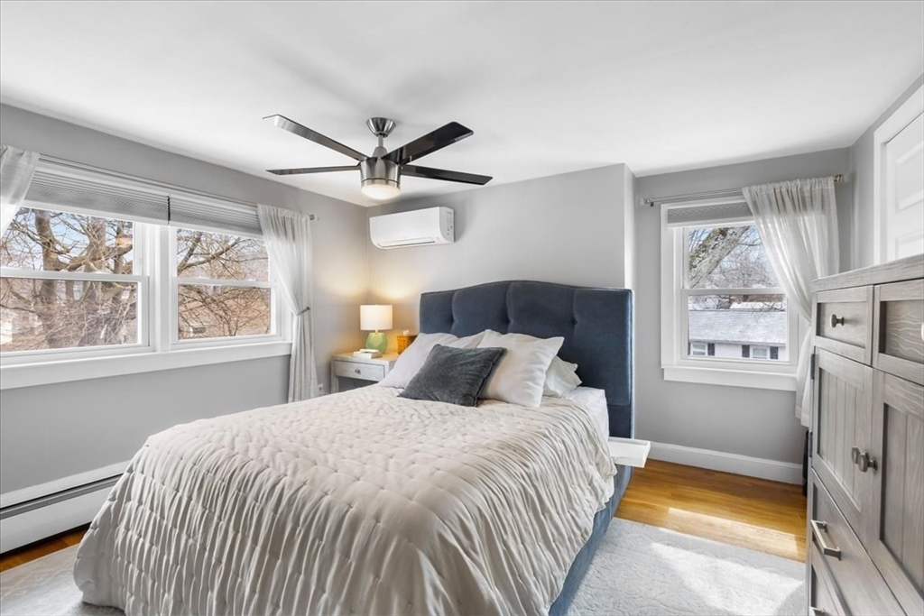 10 Earnshaw Street Boston, MA 02132 - Photo 18 of 35 a bedroom with a large bed and a window