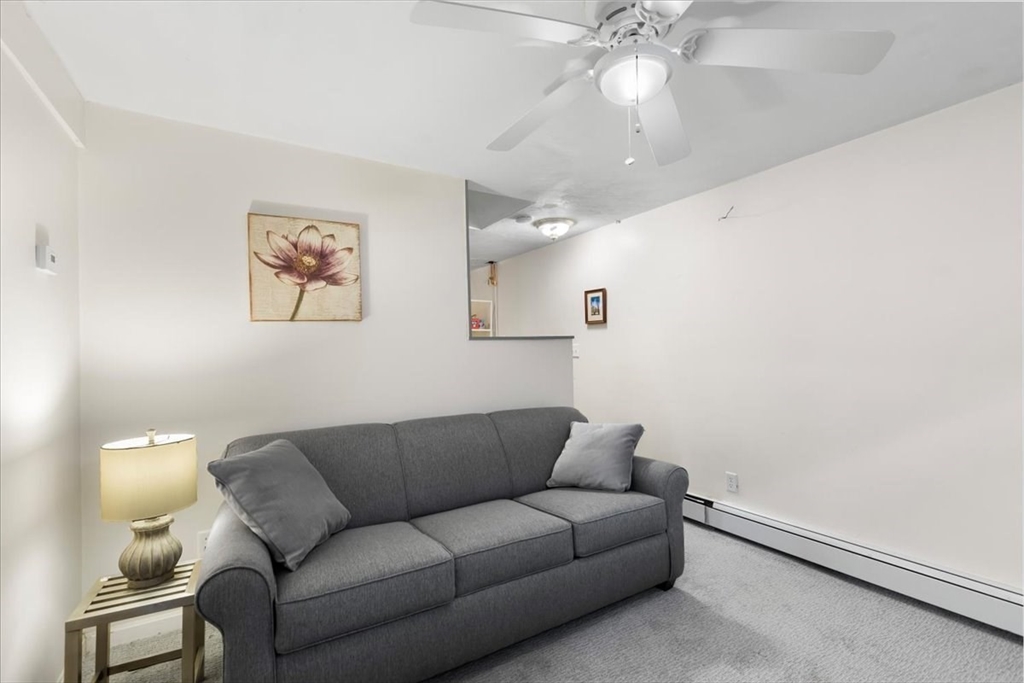 10 Earnshaw Street Boston, MA 02132 - Photo 25 of 35 a living room with furniture and a chandelier