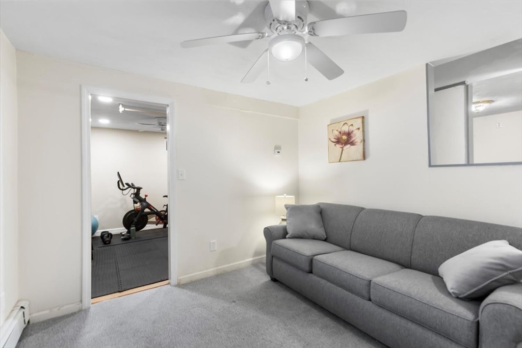 10 Earnshaw Street Boston, MA 02132 - Photo 26 of 35 a living room with furniture a ceiling fan and a rug