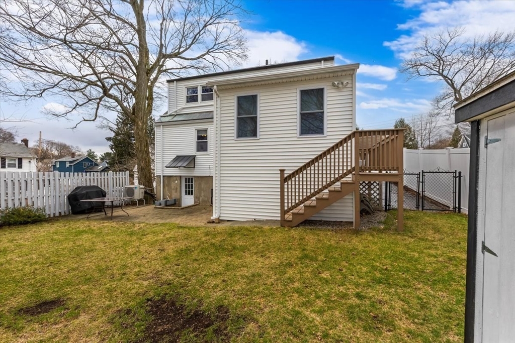 10 Earnshaw Street Boston, MA 02132 - Photo 30 of 35 a view of a house with a yard patio and fire pit