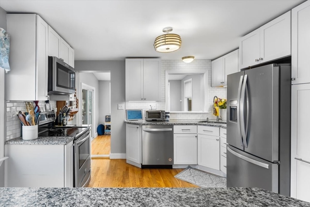 10 Earnshaw Street Boston, MA 02132 - Photo 8 of 35 a kitchen with stainless steel appliances granite countertop a refrigerator a stove a sink dishwasher and a refrigerator