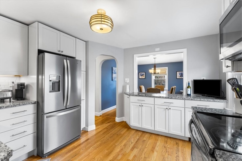 10 Earnshaw Street Boston, MA 02132 - Photo 9 of 35 a kitchen with stainless steel appliances a refrigerator sink and stove