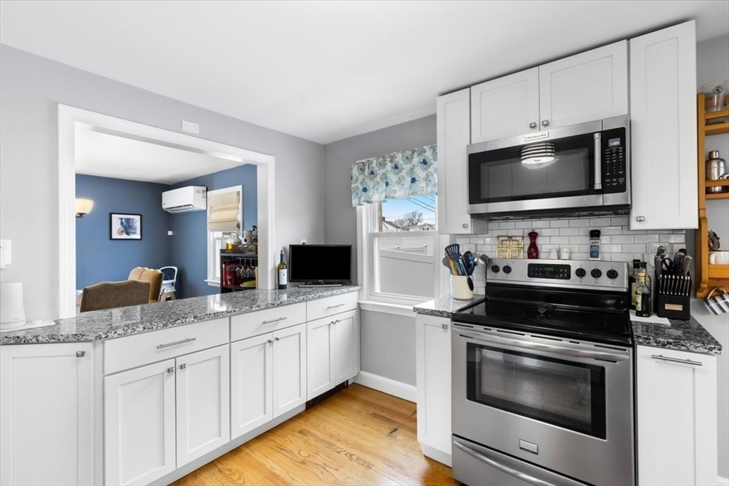 10 Earnshaw Street Boston, MA 02132 - Photo 10 of 35 a kitchen with a sink stove and microwave