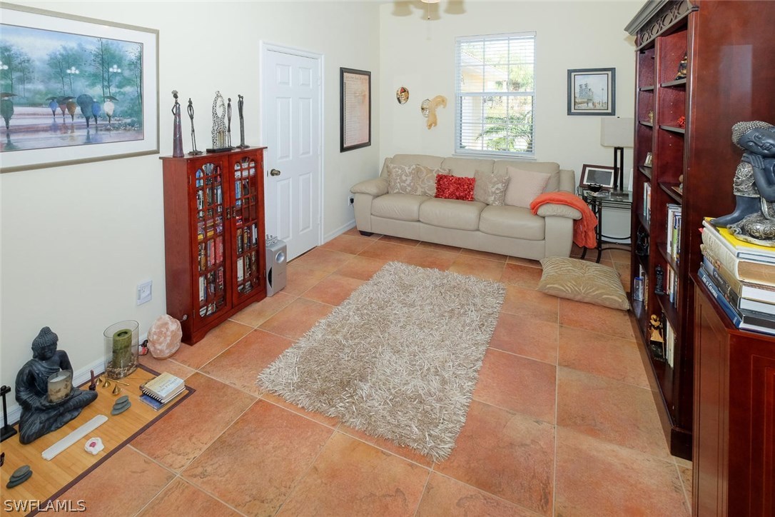 12882 Timber Ridge Drive Fort Myers, FL 33913 - Photo 13 of 25 a living room with furniture a flat screen tv and a couch