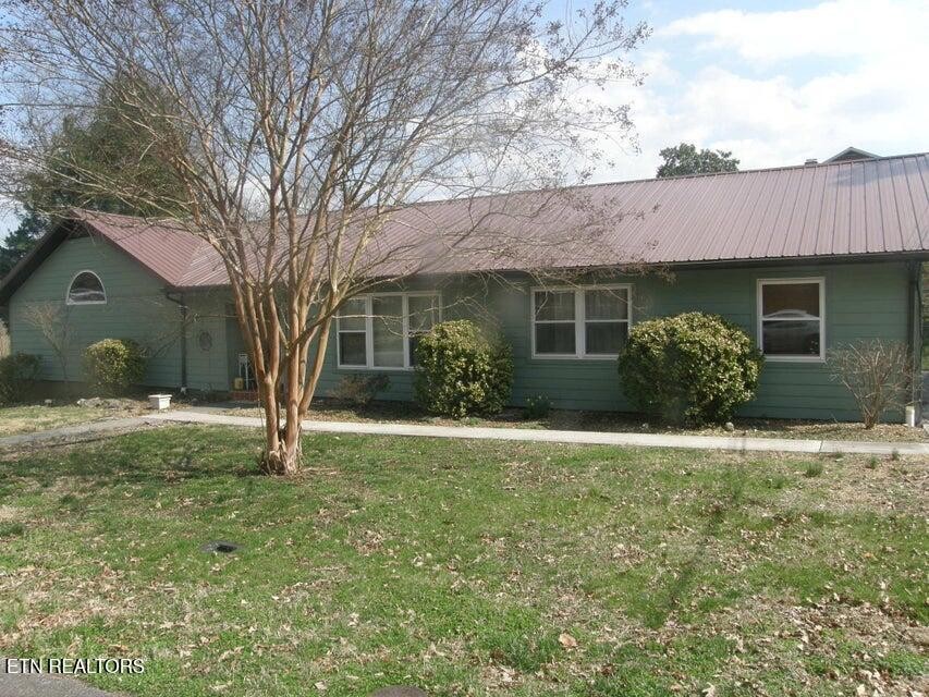 109 Malvern Road Oak Ridge, TN 37830 - Photo 1 of 1 a house with trees in front of it