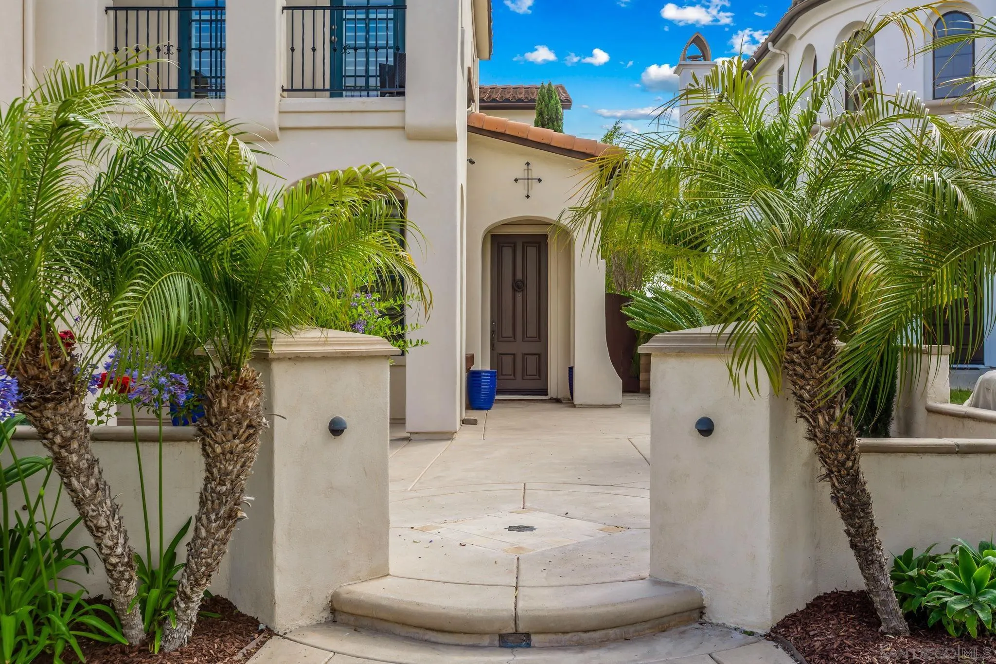 5582 Valerio Trail San Diego, CA 92130 - Photo 1 of 43 a view of a house with a potted plant and palm trees
