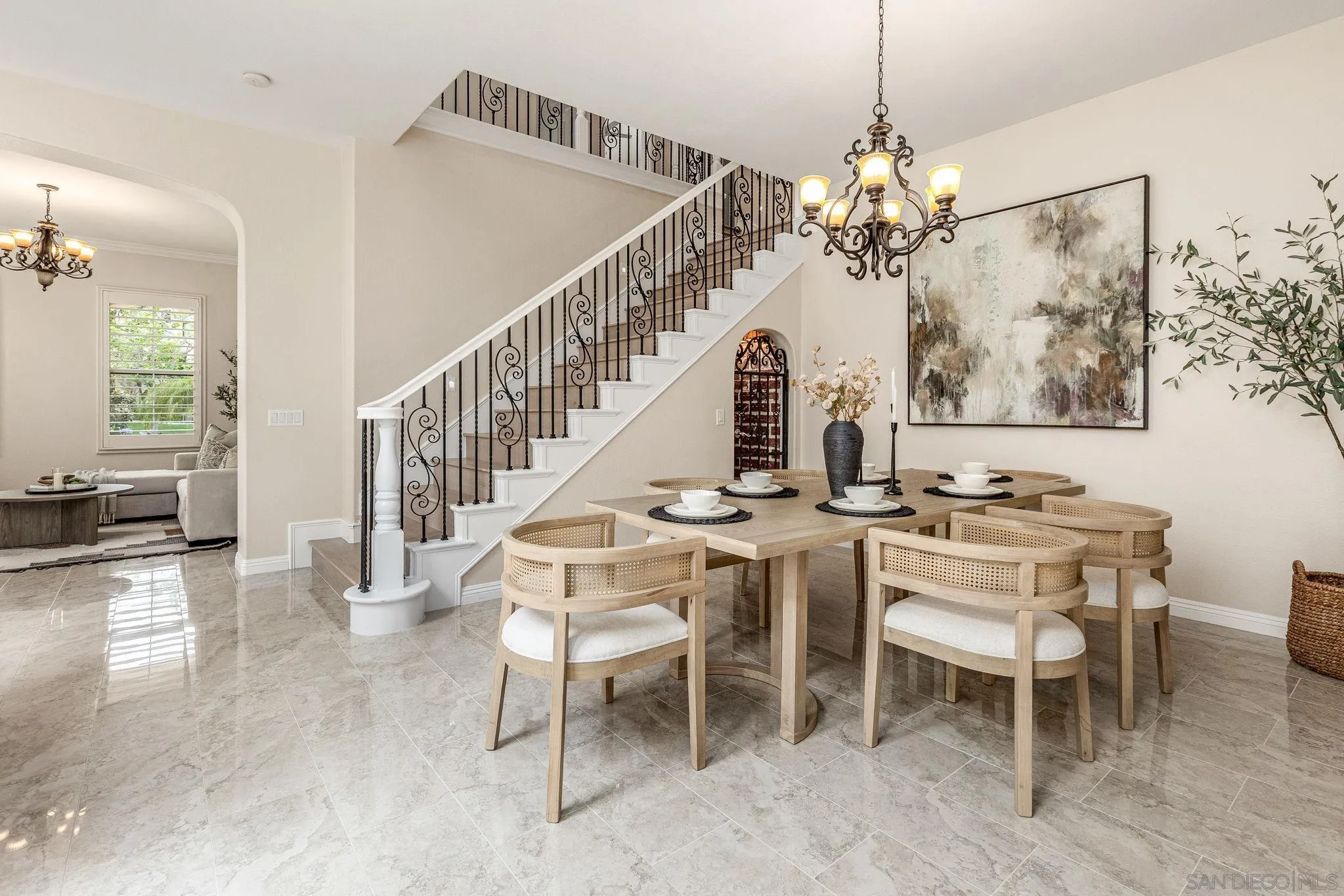 5582 Valerio Trail San Diego, CA 92130 - Photo 17 of 43 a dining room with wooden floor a chandelier a wooden table and chairs