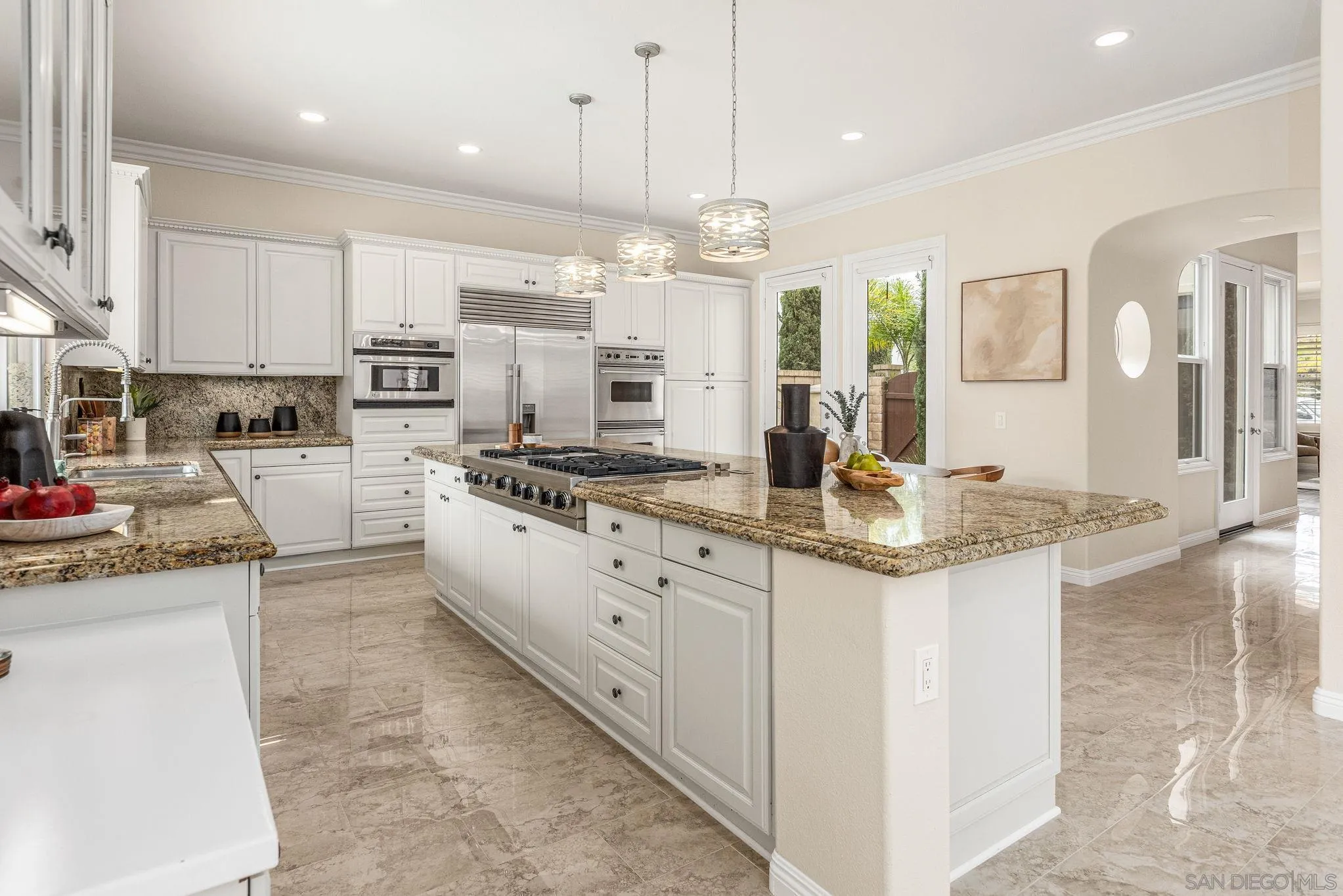 5582 Valerio Trail San Diego, CA 92130 - Photo 4 of 43 a kitchen with stainless steel appliances kitchen island granite countertop a stove top oven a sink a counter top space and cabinets