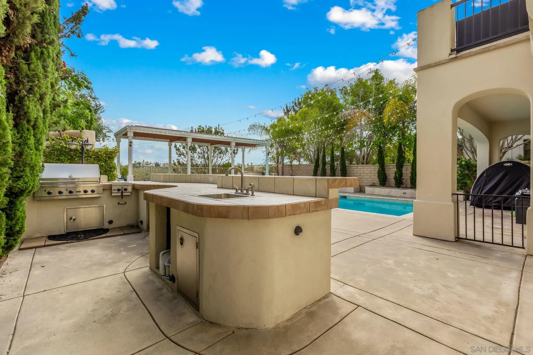 5582 Valerio Trail San Diego, CA 92130 - Photo 8 of 43 a view of a kitchen with a sink and dishwasher with chairs