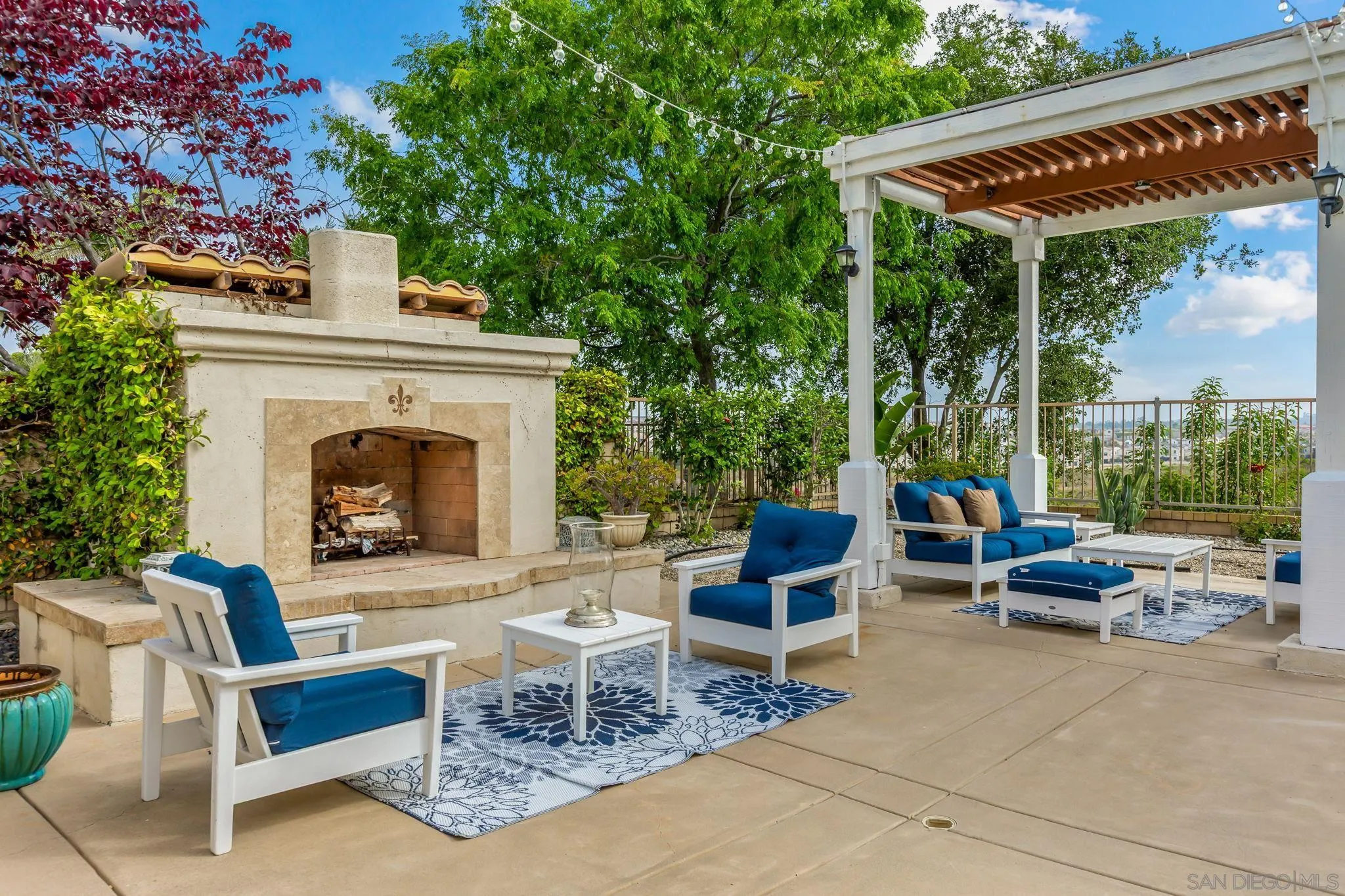 5582 Valerio Trail San Diego, CA 92130 - Photo 9 of 43 a view of a patio with a dining table and chairs with a fire pit