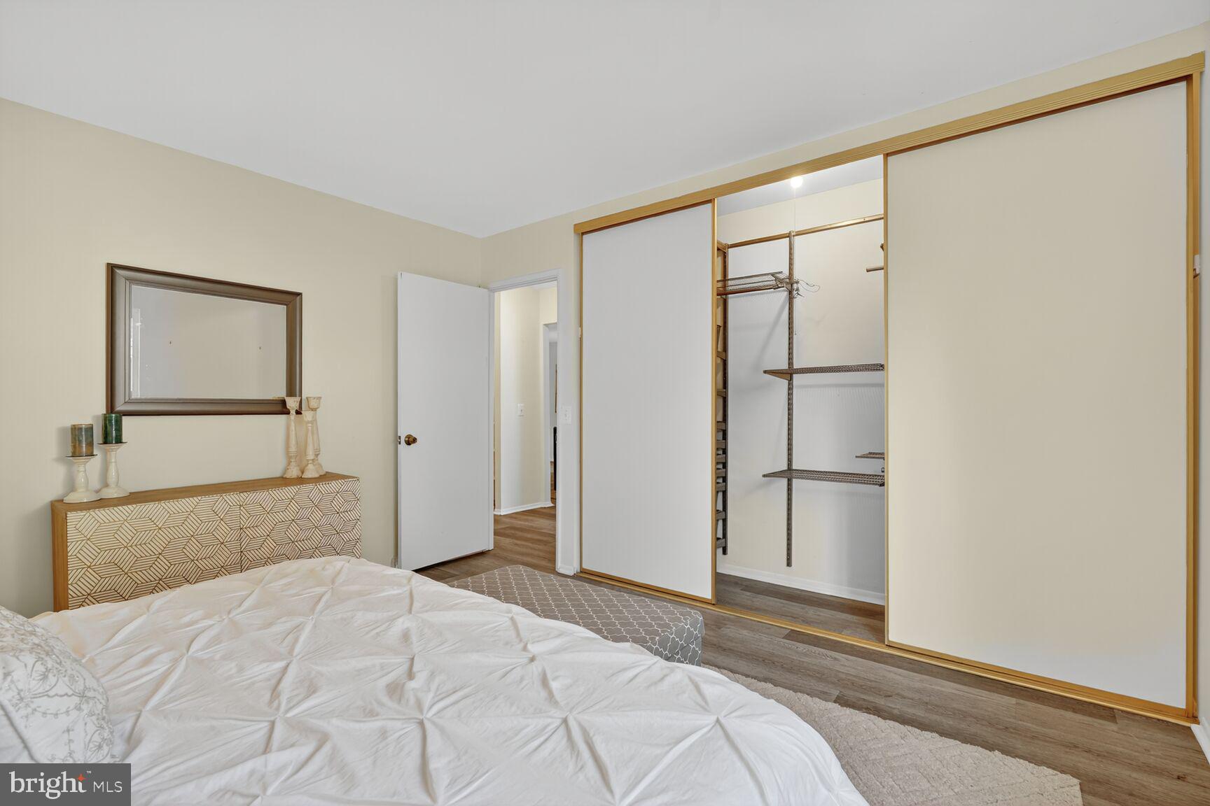 3110 Adderley Court, Unit 245A Silver Spring, MD 20906 - Photo 10 of 27 a bedroom with a bed and a large mirror