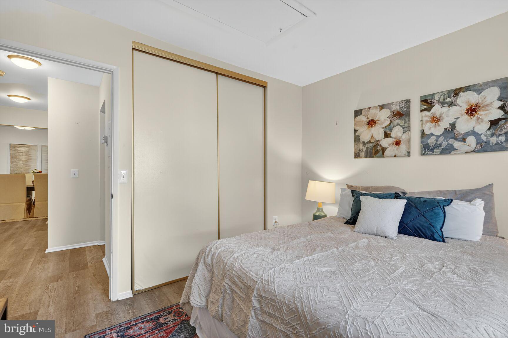 3110 Adderley Court, Unit 245A Silver Spring, MD 20906 - Photo 14 of 27 a bedroom with a large bed and wooden floor