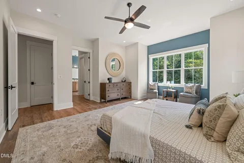 a bedroom with a bed a window and a chandelier