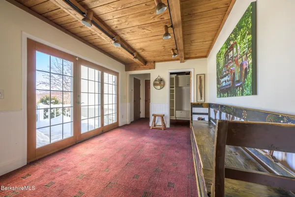 a living room with furniture a rug and a floor to ceiling window