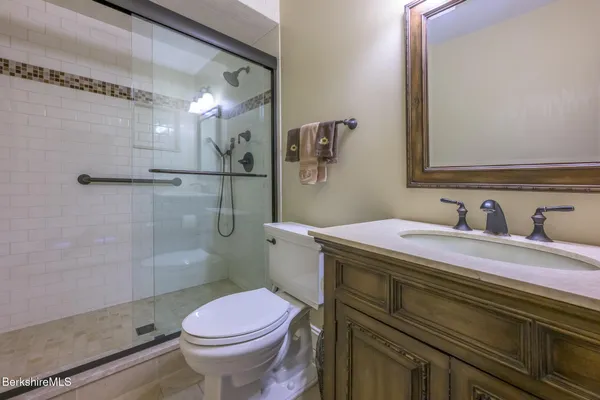 a bedroom with a bed and glass door