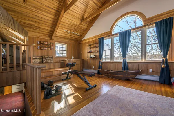 a bedroom with double bed and a large window