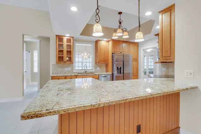 a view of a kitchen with granite countertop a sink and dishwasher