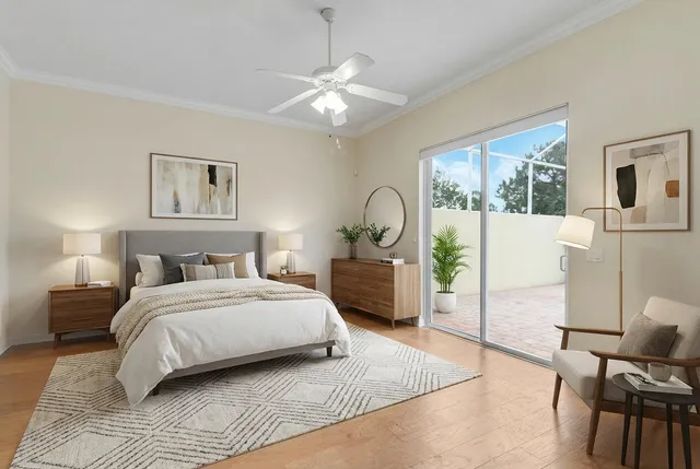 a bedroom with a large bed and a chandelier