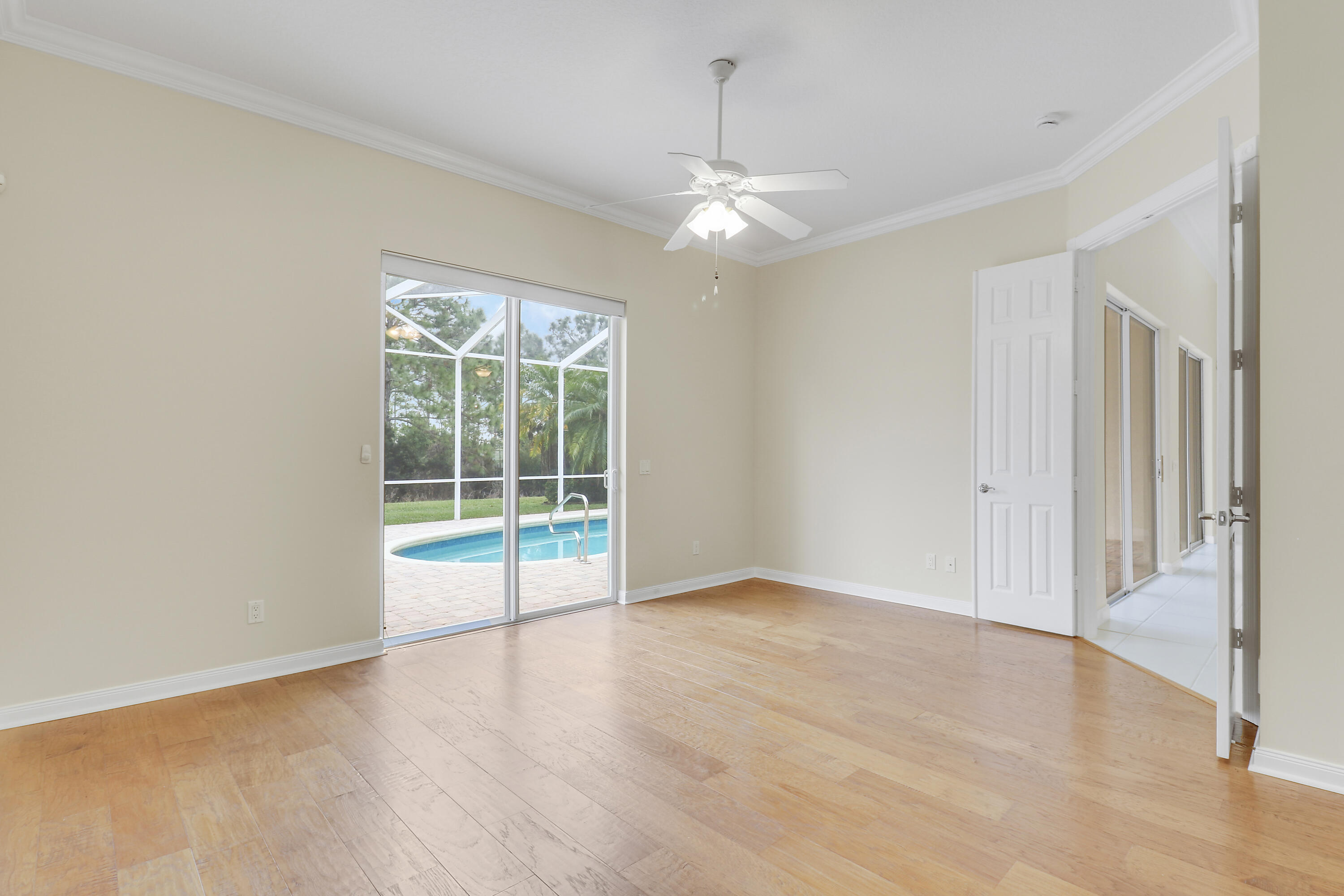 8657 Southeast Nicolete Lane Hobe Sound, FL 33455 - Photo 23 of 50 an empty room with wooden floor and windows