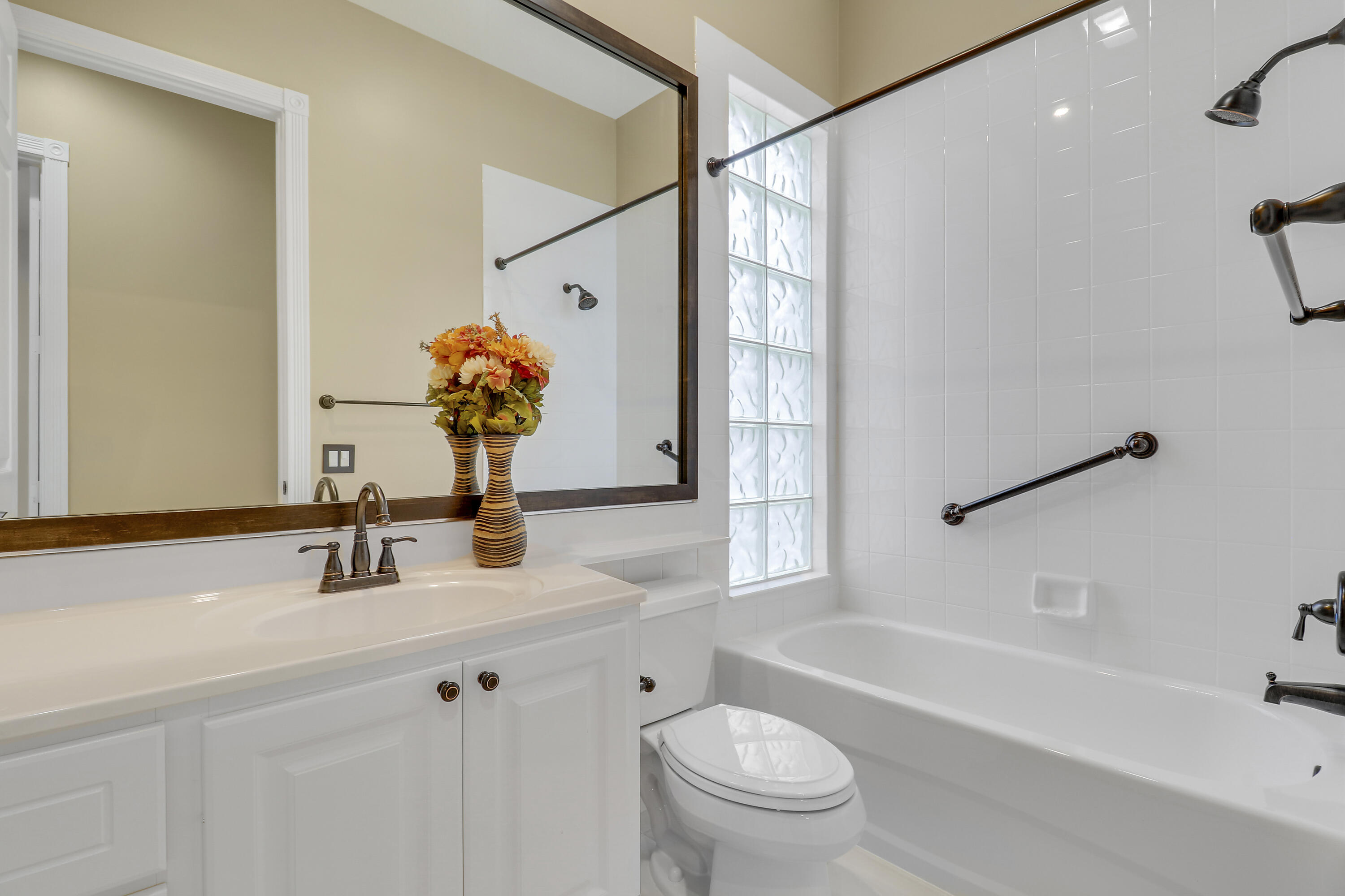 8657 Southeast Nicolete Lane Hobe Sound, FL 33455 - Photo 31 of 50 a bathroom with a sink a toilet and a bathtub