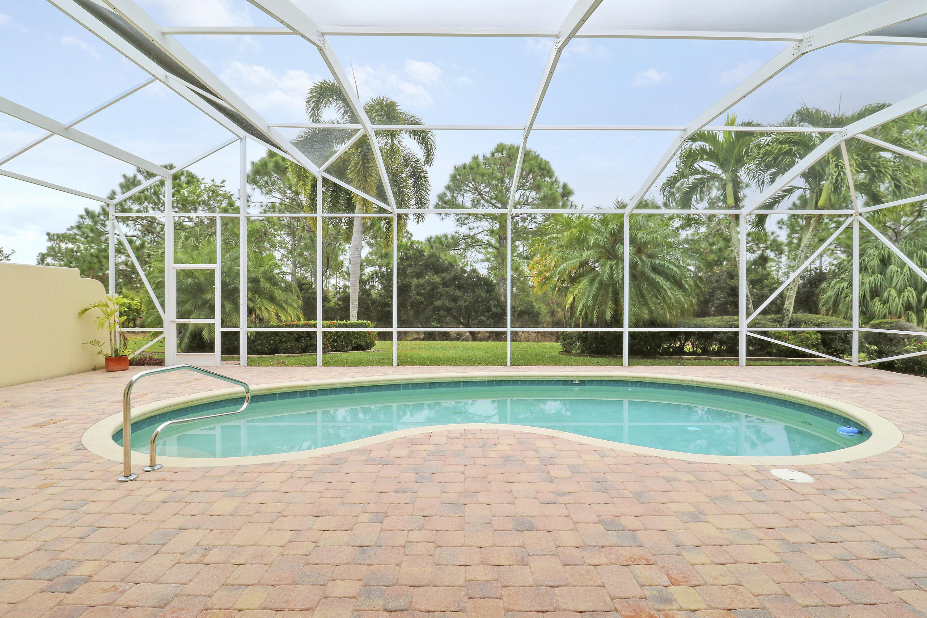 8657 Southeast Nicolete Lane Hobe Sound, FL 33455 - Photo 39 of 50 a view of a backyard with swimming pool