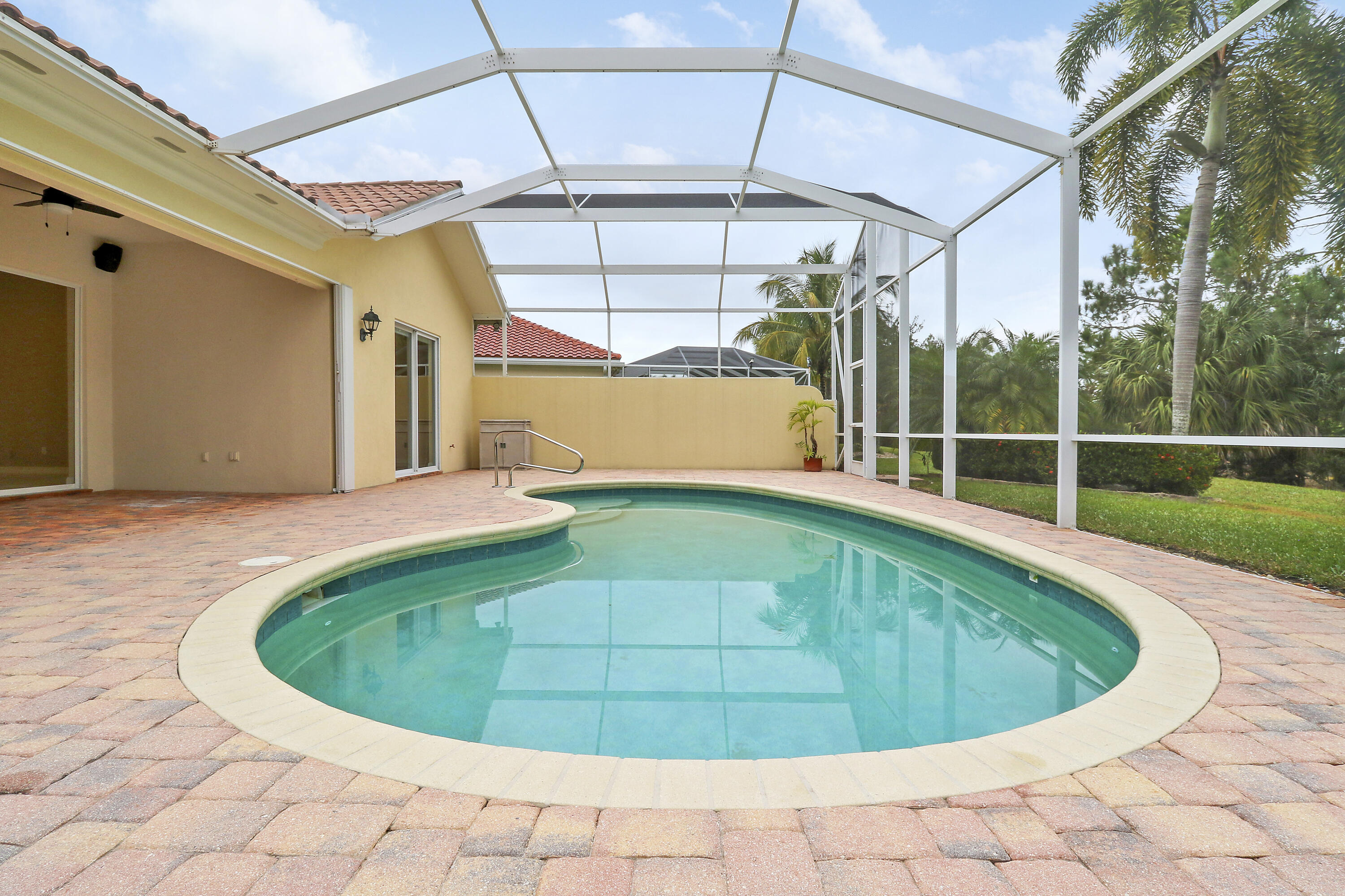 8657 Southeast Nicolete Lane Hobe Sound, FL 33455 - Photo 40 of 50 a view of a swimming pools under an umbrella