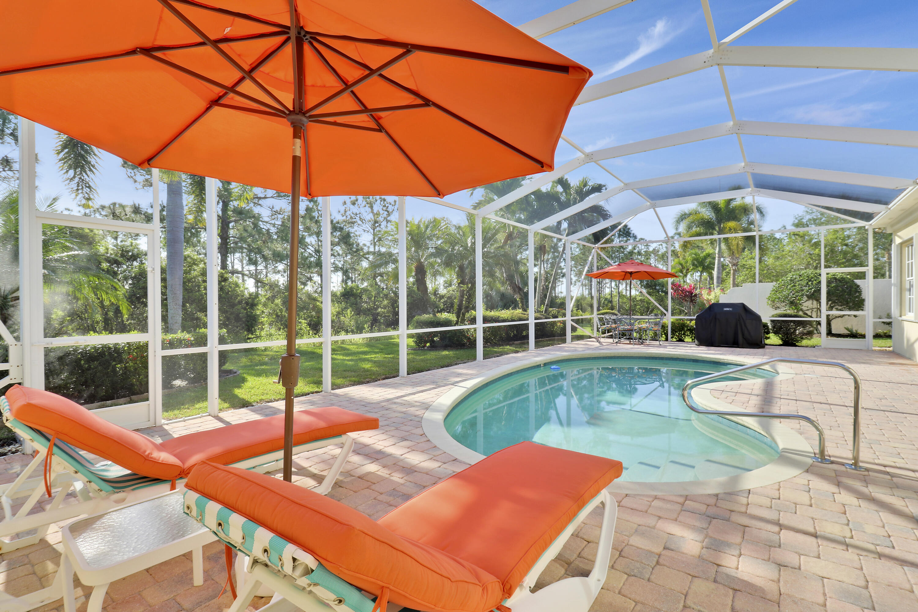 8657 Southeast Nicolete Lane Hobe Sound, FL 33455 - Photo 4 of 50 a view of a backyard with swimming pool and porch