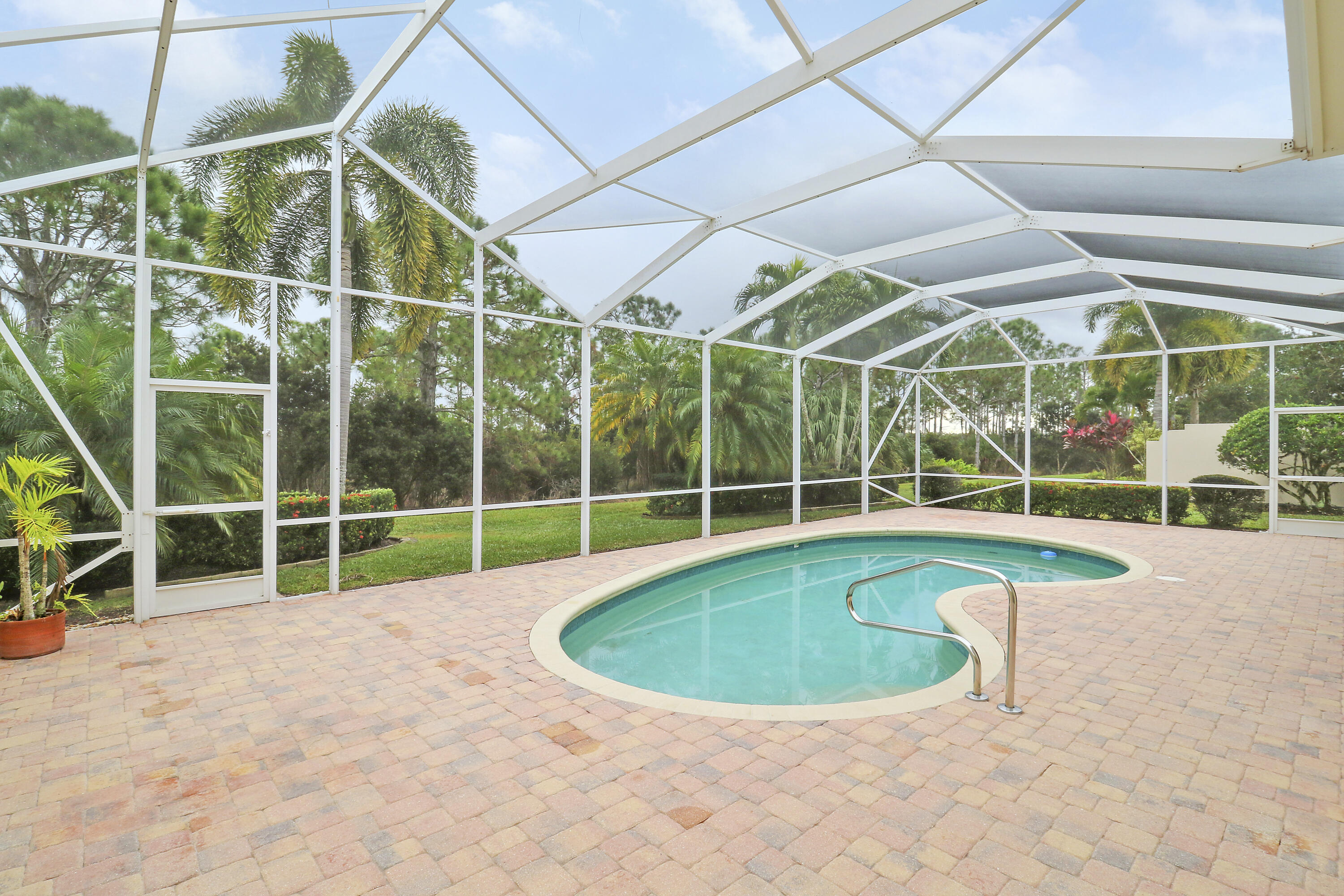 8657 Southeast Nicolete Lane Hobe Sound, FL 33455 - Photo 42 of 50 a view of a swimming pool with a yard