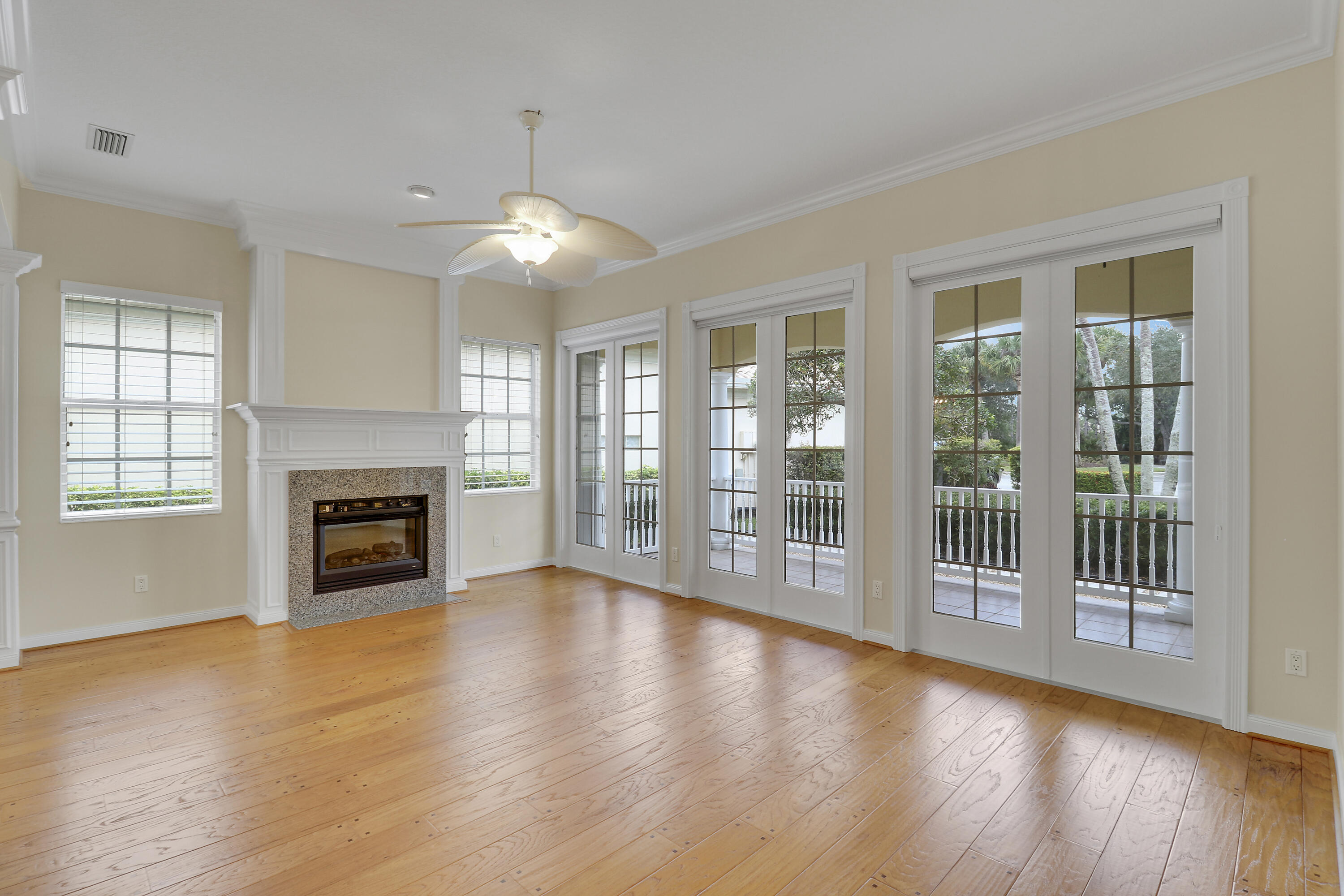 8657 Southeast Nicolete Lane Hobe Sound, FL 33455 - Photo 7 of 50 a view of a livingroom with fireplace wooden floor and windows