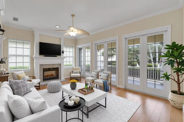 a living room with furniture a fireplace and a flat screen tv