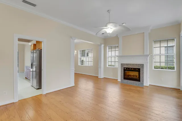 a view of an empty room with a fireplace and a window