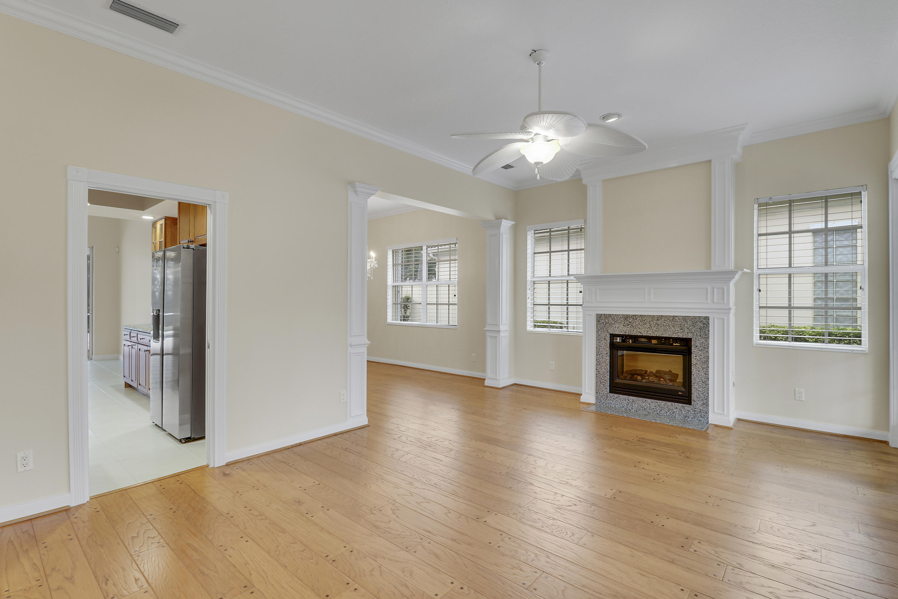 8657 Southeast Nicolete Lane Hobe Sound, FL 33455 - Photo 9 of 50 a view of an empty room with a fireplace and a window
